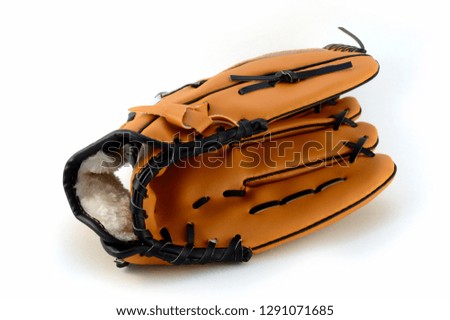 An isolated shot of a new baseball glove for playing team sports.