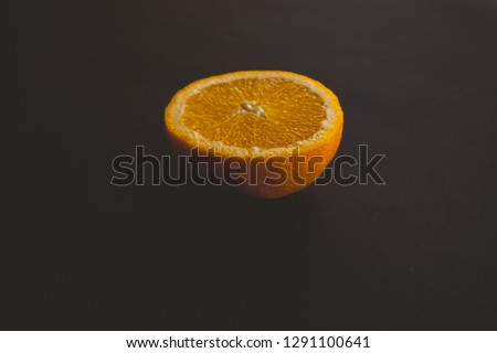 sliced orange on black background