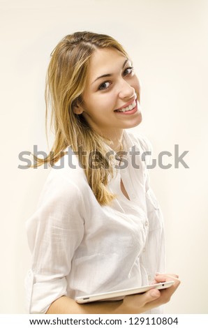 smiling pretty girl holding tablet and looking at camera