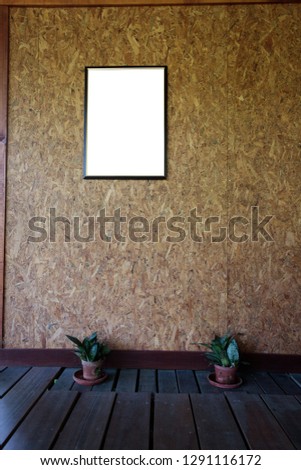 Blank ad copy insert your photo here poster frame on plywood wall Royalty-Free Stock Photo #1291116172