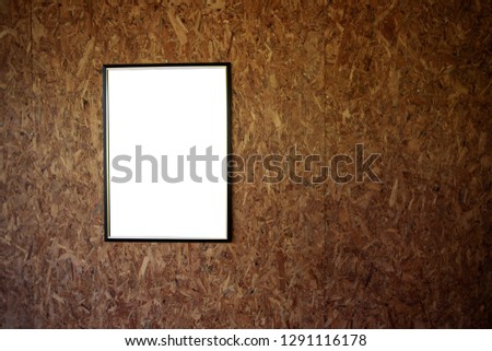 Blank ad copy insert your photo here poster frame on plywood wall Royalty-Free Stock Photo #1291116178