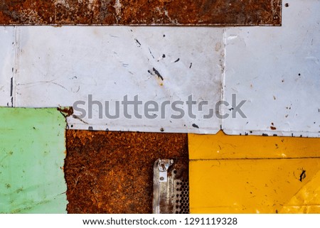 Old iron sheet, beautiful colors, many colors Arranged on the wall with rust and uneven surfaces Makes it feel bright and exciting as the red, yellow, blue, white, green background texture image