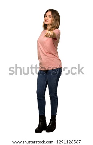 A full-length shot of a Teenager girl with pink sweater showing and lifting a finger on isolated white background