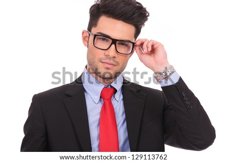 closeup picture of a young business man holding his eyeglasses and looking at the camera, on white background