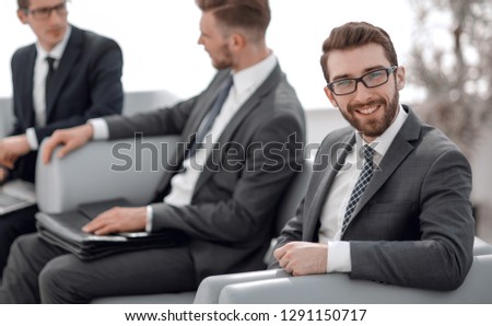 successful businessman sitting in the lobby of the business center