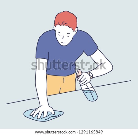 A man is washing his desk with detergent and a rag. hand drawn style vector design illustrations.