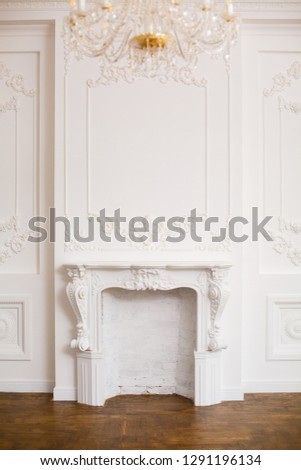 Elegant white fireplace in beautiful white room