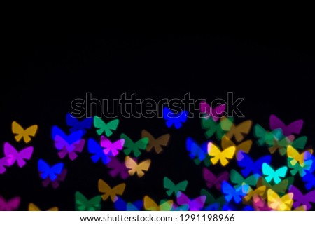 Abstract butterflies of numerous multi color on a dark background, Abstract  butterfly bokeh on half bottom of backgrounds 