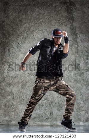 cool looking and stylishly dressed dancer posing