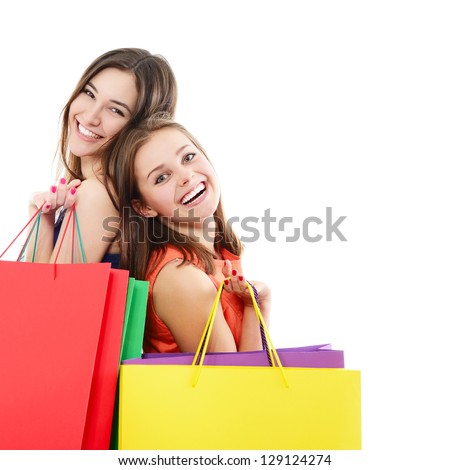 beautiful happy teen girls with colored shopping sale bags over white