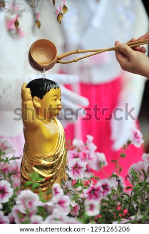 Pouring water onto a Buddha statue on the Buddha's birthday 