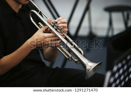A man playing a trumpet during a live performance.