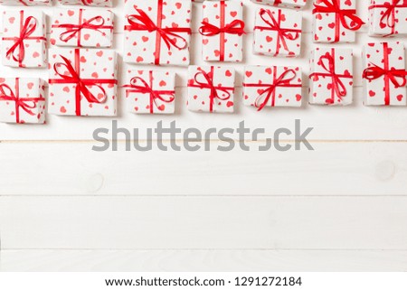 many gift boxes with red ribbon and heart. valentine or other holidays concept. top view with copy space for text or design on wooden background.