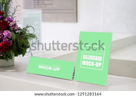 Mock up two shape of label blank in acrylic frame on reception counter in modern building, Empty green screen space stand for insert text or massage information, promotion or announcement 