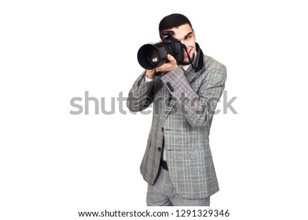 photographer at work. stylish young bearded guy takes pictures on digital camera. isolated on white