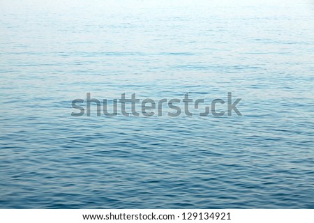Water surface with brightness in the distance Royalty-Free Stock Photo #129134921