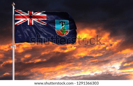 flag of Montserrat on flagpole fluttering in the wind against a colorful sunset sky