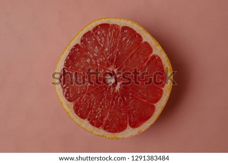 Half of ripe pink grapefruit on living coral background color year 2019, top view, copy space