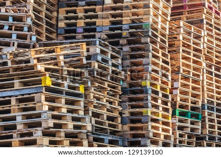 Stacks of colorful wooden euro pallets