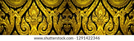 Closeup Thai pattern carving lotus picture at door in temple 