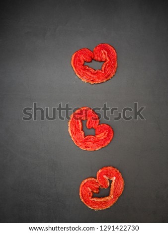 Strawberry sugar puff heart-shaped on black granite board background, Composition with free space for text or design Valentine's Day and Mother's Day