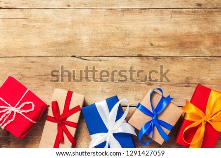 Many gift boxes on wooden background. Holiday concept, New Year, Christmas, Birthday, Valentine's Day. Flat lay, top view.