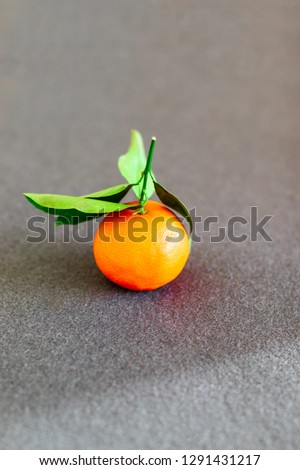 Fresh juicy clementine mandarin tangerine or mandarin fruit on grey background