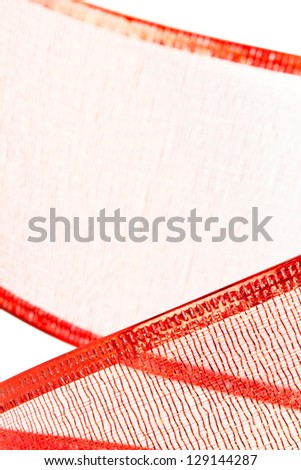 Closeup of red Christmas ribbon forms textured background.