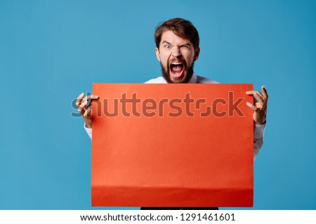 Aggressive man with a red sheet of paper                           