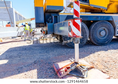 Extended side hydraulic outrigger to increase crane stability until is under heavy duty.  Royalty-Free Stock Photo #1291464658
