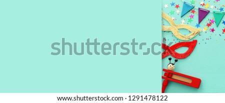 Purim celebration concept (jewish carnival holiday) over wooden blue background