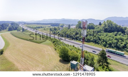 Road is going along the fields. The countryside in Slovenia is fascinating. Summer time. Aerial shot.