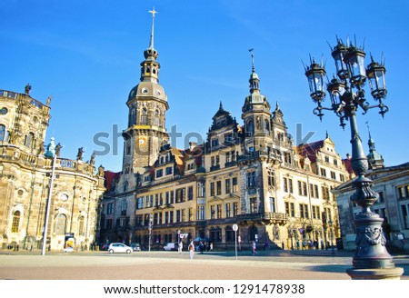 Theaterplatz square in Dresden, Germany. Cityscape of amazing architectural  buildings, domes and roofs. Cloudless spring day. View of the ancient city center, Hofkirche, and big lanters