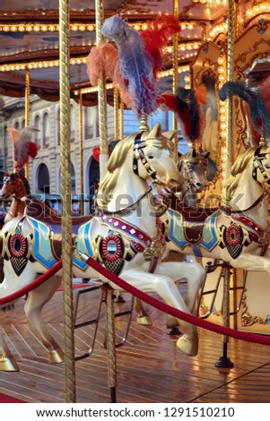 Traditional classic French styled vintage colorful horse carousel in the town square