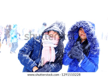 two sisters happy with falling snow at gala yuzawa,Japan