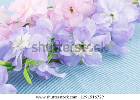 Pink fabric flowers on cloth background, closeup picture.