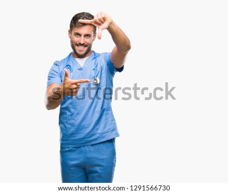 Young handsome doctor surgeon man over isolated background smiling making frame with hands and fingers with happy face. Creativity and photography concept.