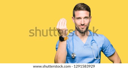 Handsome doctor man wearing medical uniform over isolated background Doing Italian gesture with hand and fingers confident expression