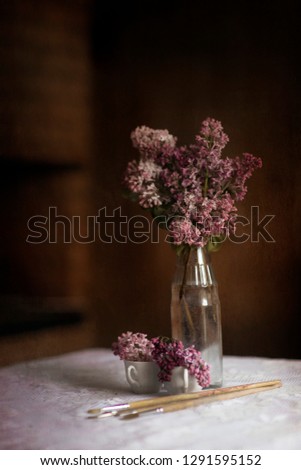 Creative still life with lilacs on an abstract dark background.very peri. Color of the year 2022. Product mockup with copy space.stylish picture for the interior,large size.still life with a dark key.