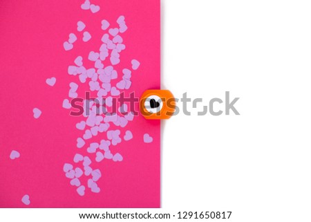 Valentine's Day paper cut background with paper hearts. Purple and pink background. Hole puncher, kids craft idea for invitation card. 