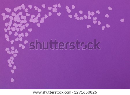 Valentine's Day paper cut background with paper hearts. Purple and pink background. Hole puncher, kids craft idea for invitation card. 
