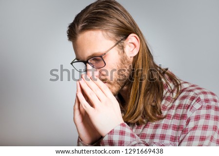 handsome man praying, asking for forgiveness, isolated closeup