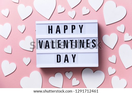 Happy Valentin's Day lightbox message with white hearts on a pink background