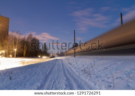 Motion blurred train passing by in the winter