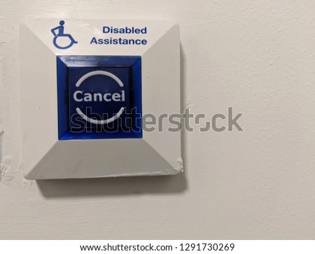 Disabled Assistance button on quite a rough wall in a disabled access toilet