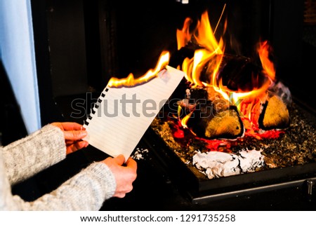 young women burns a sheet of paper