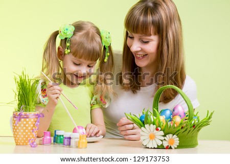 mother and child girl prepare to easter