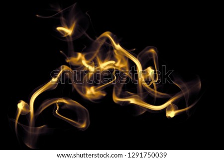 Abstract gold smoke on dark free  background, Soft movement glitter fire flame. Art flare and texture of amazing magic golden natural cloud on black background. light effect for creative and design.