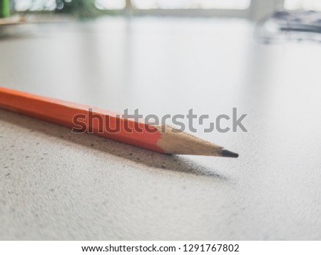 orange pencil on the table