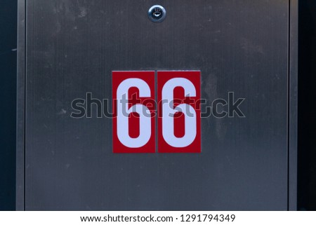 Close up of number 66 on a door